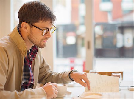 drinking coffee in a cafe - Man drinking coffee in cafe Stock Photo - Premium Royalty-Free, Code: 6113-07542526