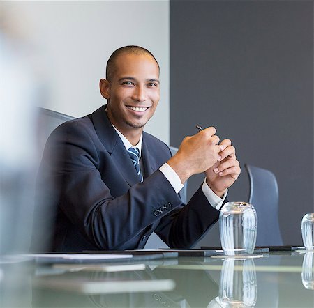 Businessman smiling in meeting Stock Photo - Premium Royalty-Free, Code: 6113-07542640