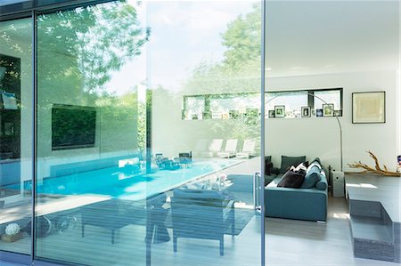 swimming pool nobody outdoor day - Reflection on glass window of modern house Stock Photo - Premium Royalty-Free, Code: 6113-07542652