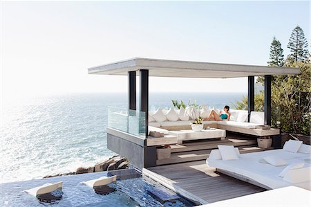simsearch:6113-07542693,k - Woman relaxing in cabana overlooking ocean Stock Photo - Premium Royalty-Free, Code: 6113-07542690