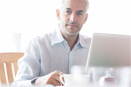 Businessman using laptop in cafe Stock Photo - Premium Royalty-Free, Code: 6113-07542613