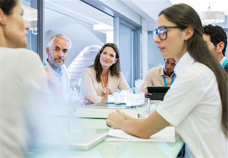 people sitting at a table - Business people talking in meeting Stock Photo - Premium Royalty-Free, Code: 6113-07542614