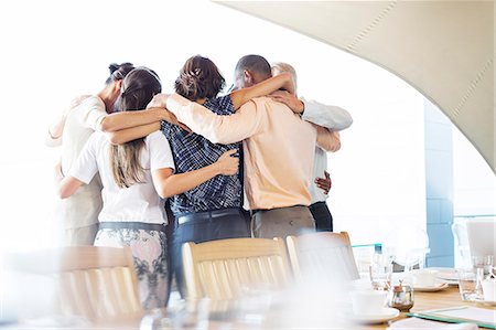 Business people talking in huddle Stock Photo - Premium Royalty-Free, Code: 6113-07542623