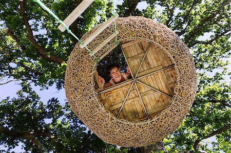 enjoy concept - Woman smiling in modern treehouse Stock Photo - Premium Royalty-Free, Code: 6113-07542706