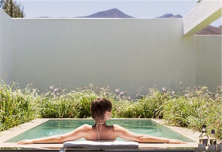 simsearch:6113-07648900,k - Woman relaxing in luxury lap pool Stock Photo - Premium Royalty-Free, Code: 6113-07542720