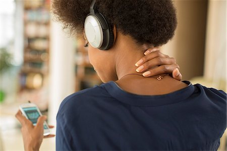 person and checking phone - Woman listening to headphones Stock Photo - Premium Royalty-Free, Code: 6113-07542850