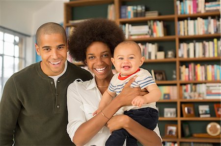 Family smiling together in living room Stock Photo - Premium Royalty-Free, Code: 6113-07542834