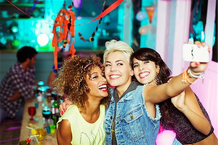 selfie - Women taking self-portrait with camera phone at party Stock Photo - Premium Royalty-Free, Code: 6113-07543018