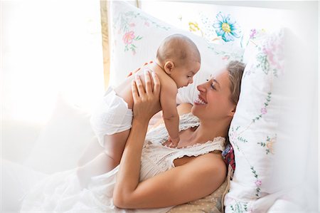 Mother holding baby boy on bed Stock Photo - Premium Royalty-Free, Code: 6113-07543161