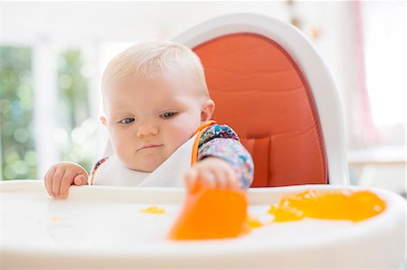 simsearch:6113-07731339,k - Baby girl eating in high chair Stock Photo - Premium Royalty-Free, Code: 6113-07543162