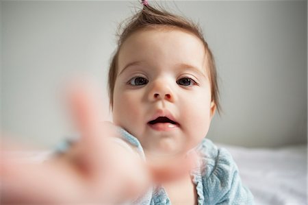 Baby girl reaching out Stock Photo - Premium Royalty-Free, Code: 6113-07543102
