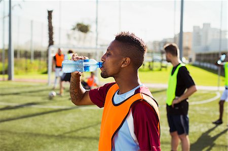 Soccer player drinking water on field Stock Photo - Premium Royalty-Free, Code: 6113-07543126