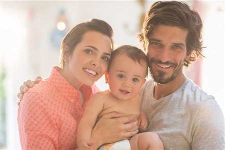 father with baby posing - Parents smiling with baby boy Stock Photo - Premium Royalty-Free, Code: 6113-07543290