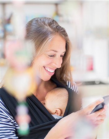 Mother with baby boy using cell phone Stock Photo - Premium Royalty-Free, Code: 6113-07543234