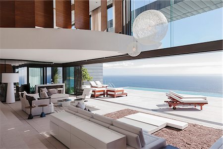 simsearch:6113-07543355,k - Living room in modern house overlooking ocean Photographie de stock - Premium Libres de Droits, Code: 6113-07543370