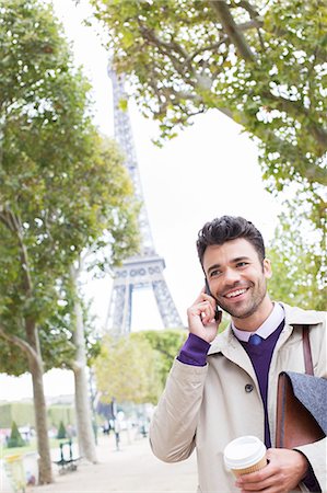 Businessman talking on cell phone near Eiffel Tower, Paris, France Stock Photo - Premium Royalty-Free, Code: 6113-07543438