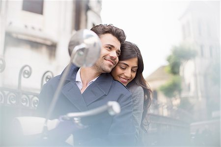 scooter with woman - Couple sitting on scooter in city Stock Photo - Premium Royalty-Free, Code: 6113-07543541