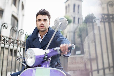 photography poses for men with scooter - Man driving scooter on city street Stock Photo - Premium Royalty-Free, Code: 6113-07543559