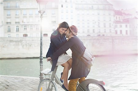 Couple hugging on bicycle along Seine River, Paris, France Foto de stock - Sin royalties Premium, Código: 6113-07543573