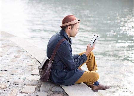 Man using digital tablet along river Stockbilder - Premium RF Lizenzfrei, Bildnummer: 6113-07543516