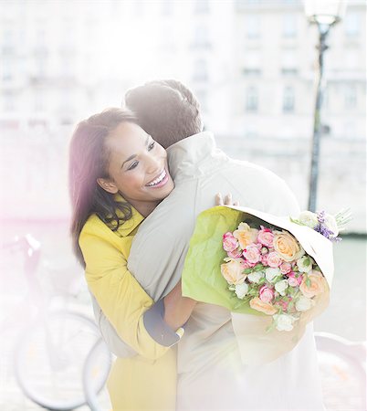 simsearch:6113-07543578,k - Couple with bouquet of flowers hugging along Seine River, Paris, France Stock Photo - Premium Royalty-Free, Code: 6113-07543648