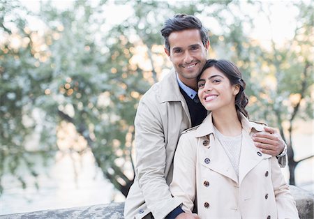 smiling brunette woman - Couple hugging in park Stock Photo - Premium Royalty-Free, Code: 6113-07543676