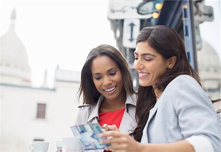 paris cafes - Women reading postcard at sidewalk cafe in Paris, France Stock Photo - Premium Royalty-Free, Code: 6113-07543630