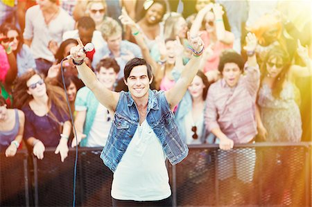 simsearch:6113-06498627,k - Portrait of performer with fans in background at music festival Stock Photo - Premium Royalty-Free, Code: 6113-07564743