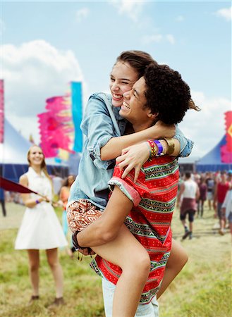 simsearch:6113-07564909,k - Enthusiastic couple hugging at music festival Stock Photo - Premium Royalty-Free, Code: 6113-07564756