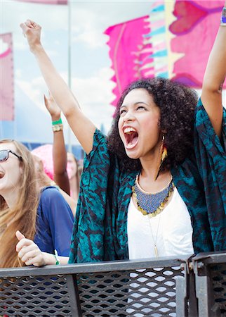 Woman cheering at music festival Stock Photo - Premium Royalty-Free, Code: 6113-07564778