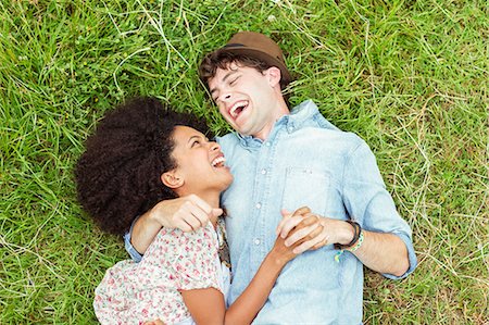 Laughing couple laying in grass Stock Photo - Premium Royalty-Free, Code: 6113-07564795