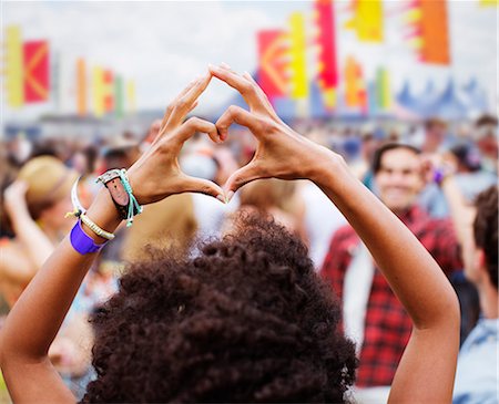 festival - Woman forming heart-shape with hands at music festival Stock Photo - Premium Royalty-Free, Code: 6113-07564842