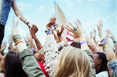 Fans reaching to shake hands with performer at music festival Stock Photo - Premium Royalty-Free, Code: 6113-07564847