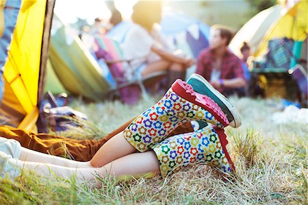 simsearch:6113-07564863,k - Couple's legs sticking out of tent at music festival Stock Photo - Premium Royalty-Free, Code: 6113-07564894