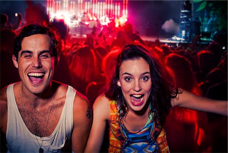 Enthusiastic couple cheering at music festival Foto de stock - Sin royalties Premium, Código: 6113-07564816