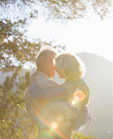 simsearch:6113-07564959,k - Senior man carrying woman outdoors Stock Photo - Premium Royalty-Free, Code: 6113-07564959