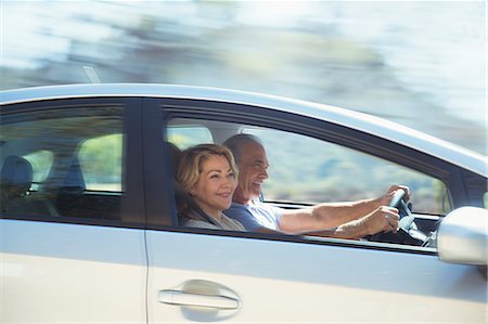 female posing on car - Happy senior couple driving in car Stock Photo - Premium Royalty-Free, Code: 6113-07564964