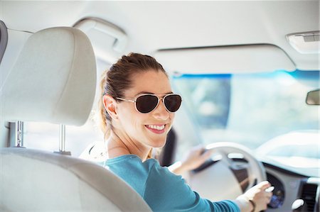 driving (vehicle) - Portrait of confident woman in sunglasses driving car Stock Photo - Premium Royalty-Free, Code: 6113-07564980