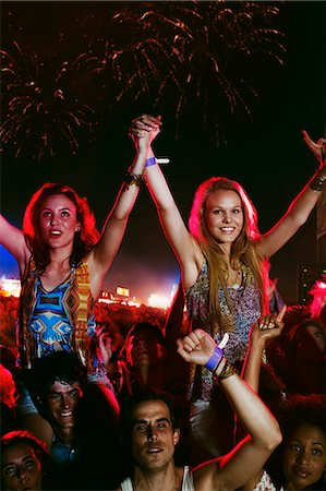 Cheering women on men's shoulders at music festival Stock Photo - Premium Royalty-Free, Code: 6113-07564928