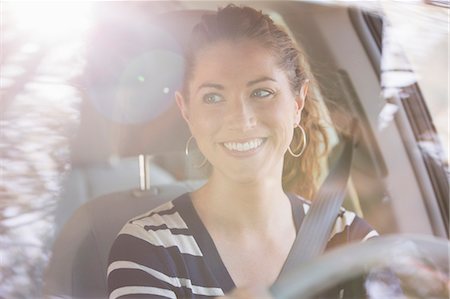 reflection (visual) - Happy woman driving car Stock Photo - Premium Royalty-Free, Code: 6113-07564939