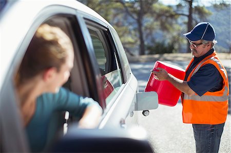 simsearch:6113-07565110,k - Woman watching roadside mechanic fill gas tank Stock Photo - Premium Royalty-Free, Code: 6113-07565054