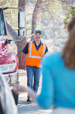 senior and saving - Roadside mechanic arriving to help woman Stock Photo - Premium Royalty-Free, Code: 6113-07565055