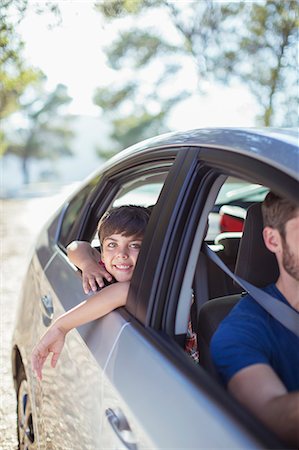 portrait with car - Portrait of smiling boy leaning out car window Stock Photo - Premium Royalty-Free, Code: 6113-07565083