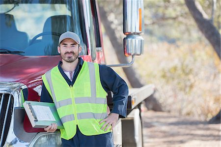 side of the road - Portrait of confident roadside mechanic leaning on truck Stock Photo - Premium Royalty-Free, Code: 6113-07565089