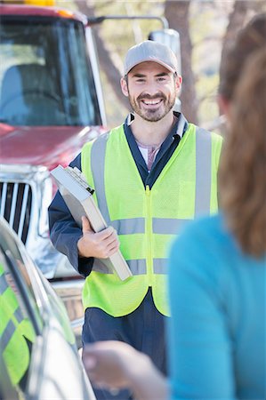 roadside assist - Roadside mechanic arriving to help woman Stock Photo - Premium Royalty-Free, Code: 6113-07565092