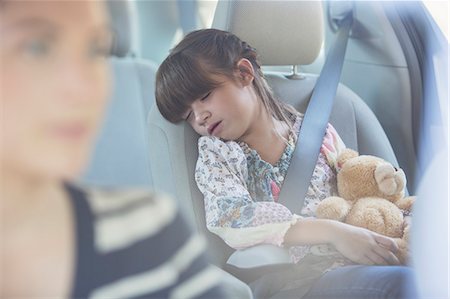 roadtrip - Girl with teddy bear sleeping in back seat of car Stock Photo - Premium Royalty-Free, Code: 6113-07565136