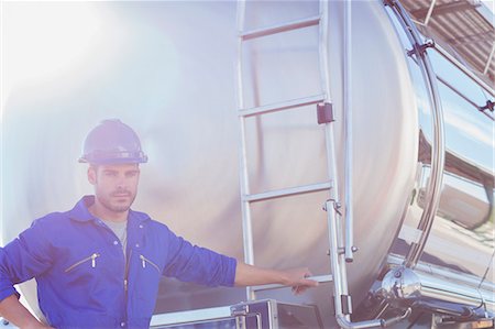 Portrait of worker at back of stainless steel milk tanker Stock Photo - Premium Royalty-Free, Code: 6113-07565326