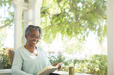 porch coffee - Happy senior woman reading book on porch Stock Photo - Premium Royalty-Free, Code: 6113-07565454