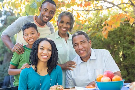 Portrait of smiling multi-generation family at patio table Stock Photo - Premium Royalty-Free, Code: 6113-07565492
