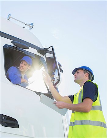 protection teamwork copy space - Worker with clipboard directing truck driver Stock Photo - Premium Royalty-Free, Code: 6113-07565423